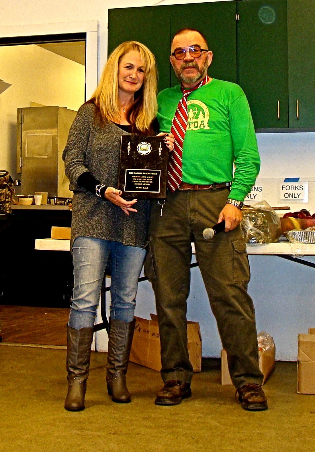 UFFDA President Daniel Hendricks presents Deb Kalk with the Diamond Arrow Award for outstanding service, awarded for only the second time in UFFDA history.